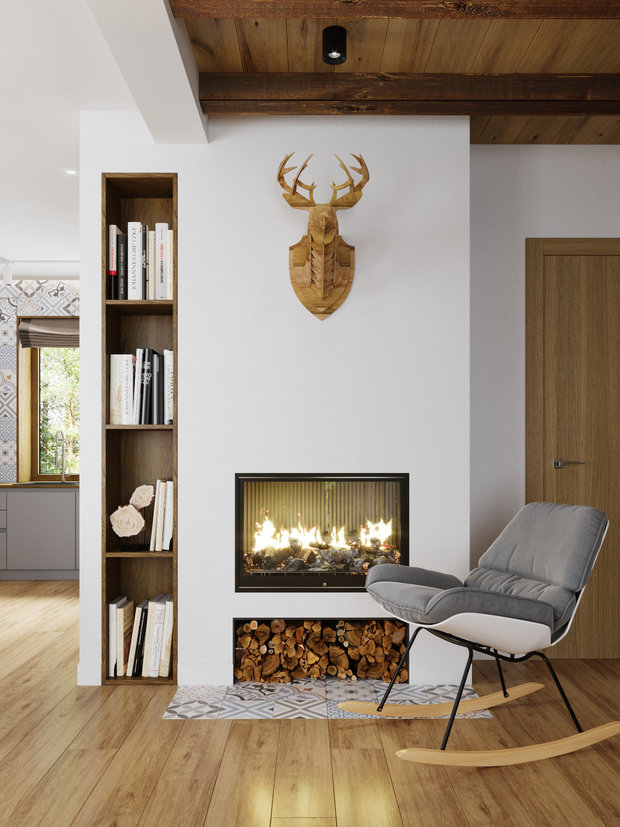 Зону очага организовали с помощью биокамина. Пол частично выложили плиткой, которую использовали на фартуке кухни. Рядом встроили открытый стеллаж для книг и декора.