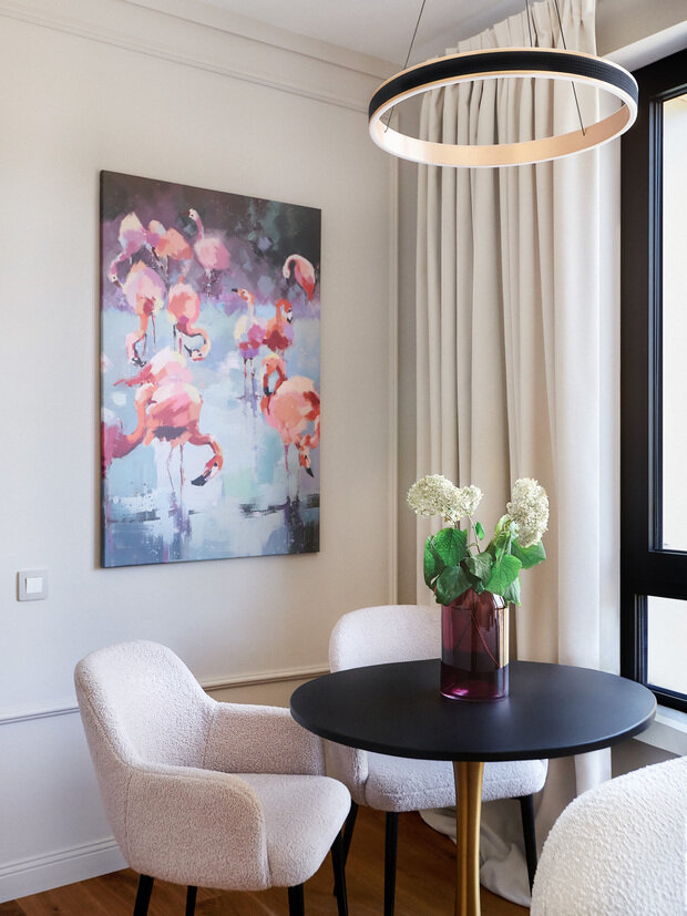 Акцентный элемент столовой зоны — изящный обеденный стол на «золотой» опоре.