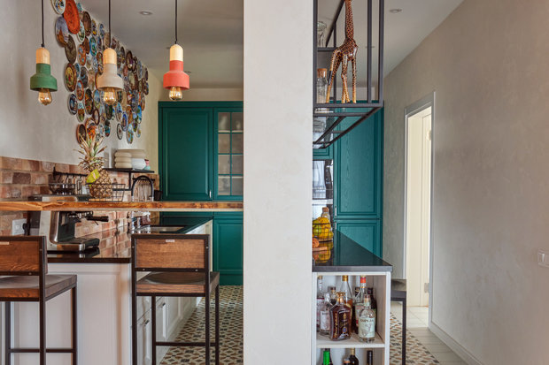 Со стороны гостиной между прихожей и несущей колонной сделали барную стойку. Гости любят проводить за ней время, пока хозяйка заканчивает приготовление ужина.