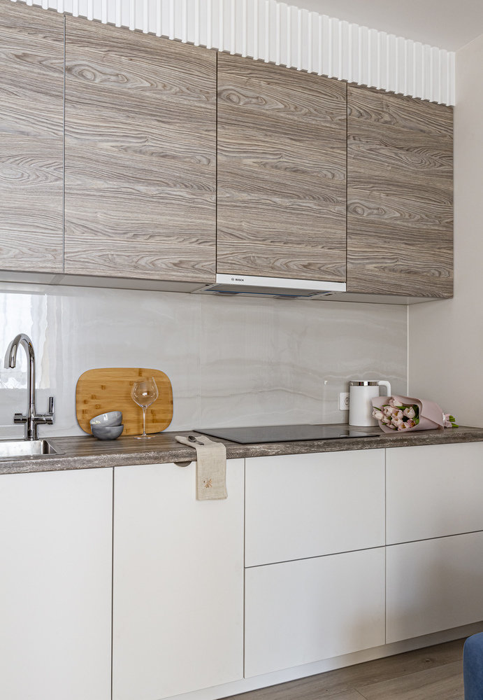 Стык столешницы и керамогранита выполнен без уголка, цвет фасадов точно совпадает с цветом керамогранита, все фасады ровно и аккуратно геометрически изготовлены.