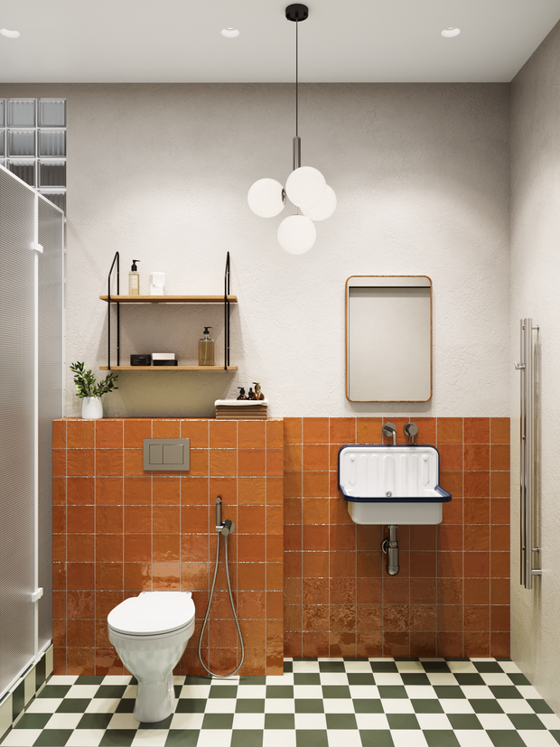 Во втором санузле ставку сделали на оранжевую плитку на стенах и клетку на полу, получилось необычно.