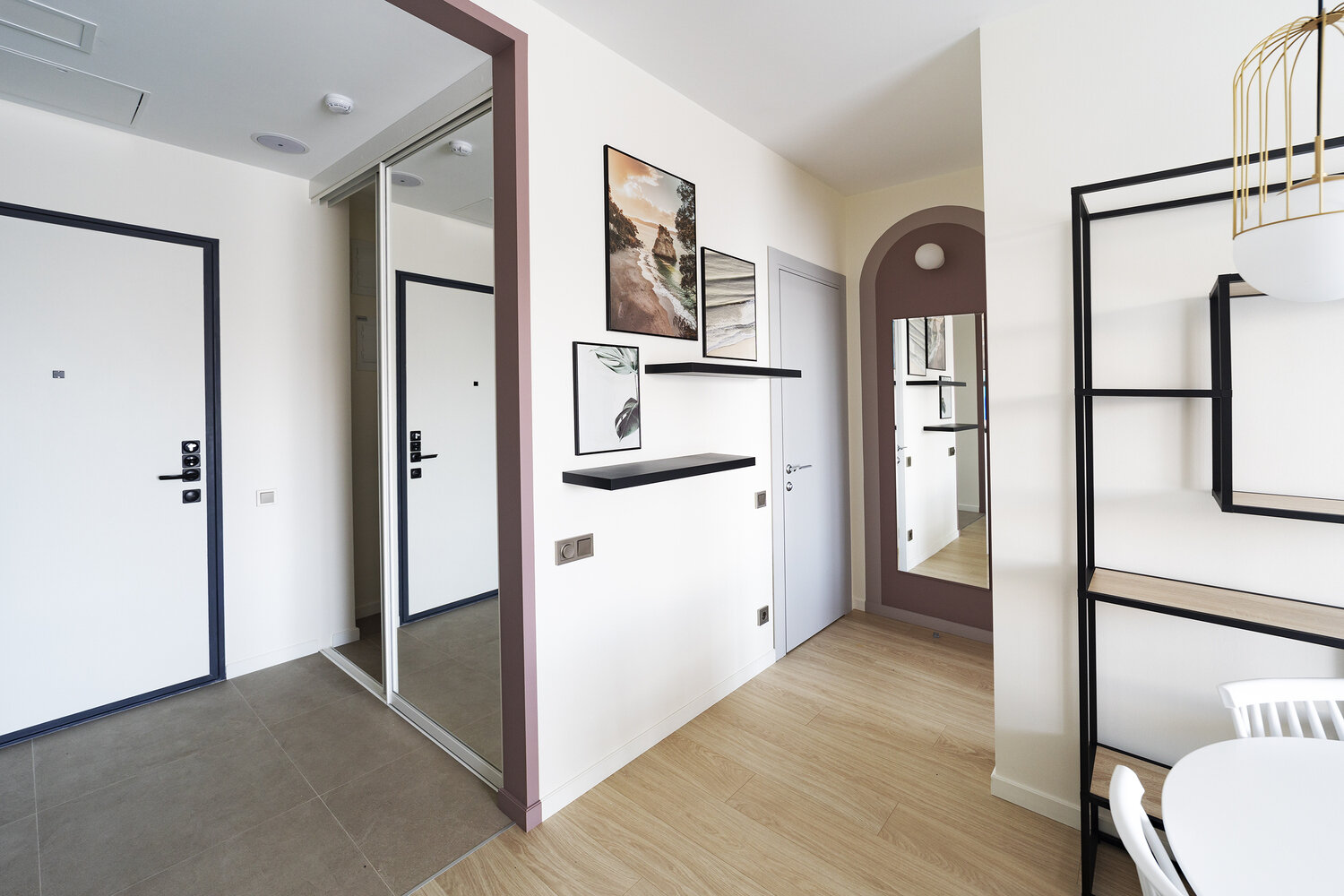 Хранение верхней одежды и обуви организовано в прихожей за раздвижными зеркальными дверями, внутри предусмотрена розетка, которая может быть использована, например, для зарядки беспроводного пылесоса.