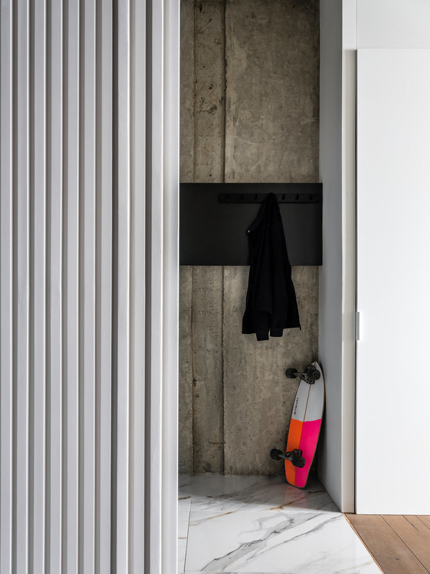 В прихожей есть деревянная полка для ключей и небольших личных вещей. Над ней расположены вешалки для повседневной верхней одежды. Также слева от двери находится зеркало высотой в потолок.