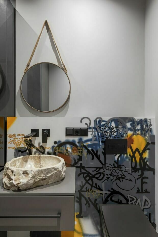 Интерьер ванной в стиле эклектика с античной раковиной и граффити на стене