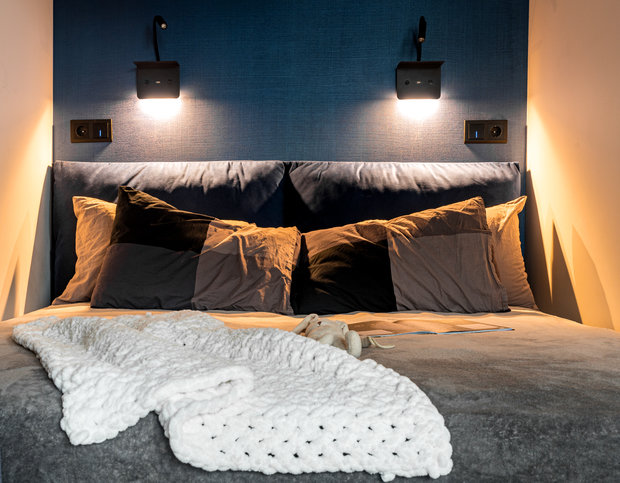 Рядом с изголовьем разместили бра с полочкой для телефона или книги, с USB-разъемом, чтобы удобно заряжать телефон.