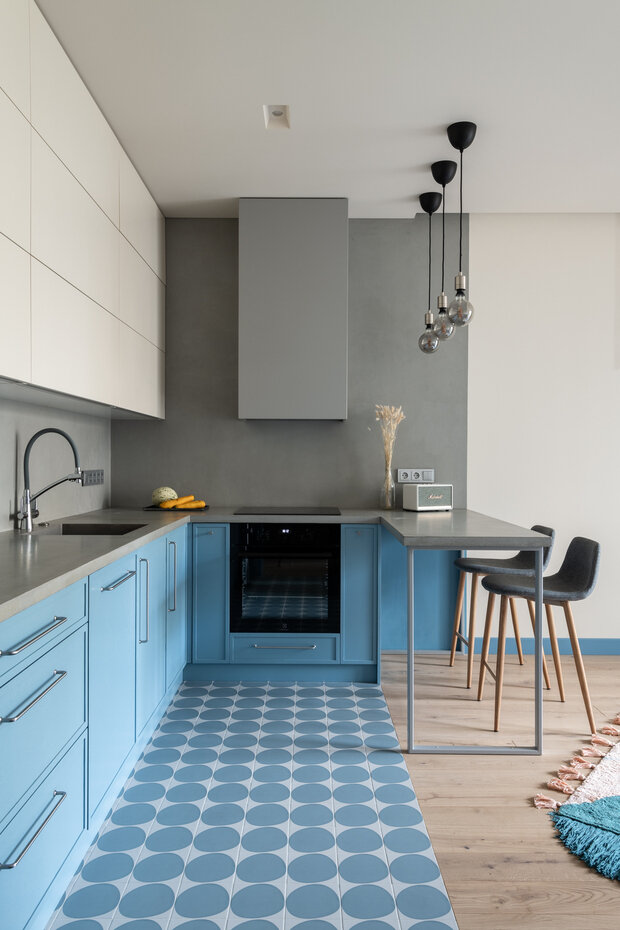 Кухню выделили с помощью цвета. Вытяжку спрятали в специальный короб, который выкрасили в цвет стены.